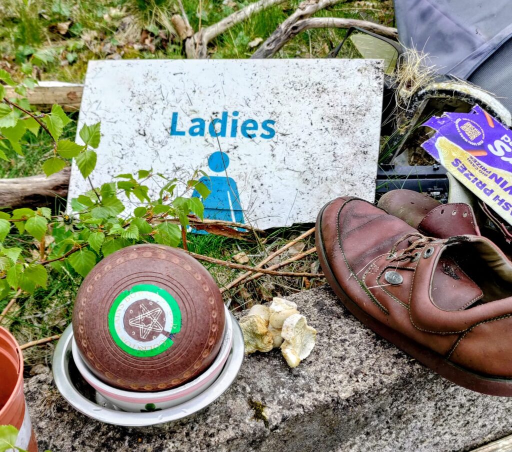 finds from a cleanup day at a disused bowling green, including a Ladies sign, a bowling ball and multiple shoes
